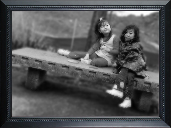 two girls on a bench